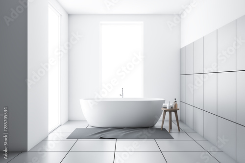 White tiled bathroom with tub and carpet