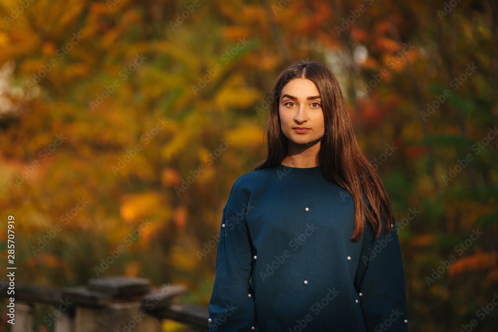 Beautiful female model walking in the forest in autumn weather Beautiful female model walking in the forest in autumn weather