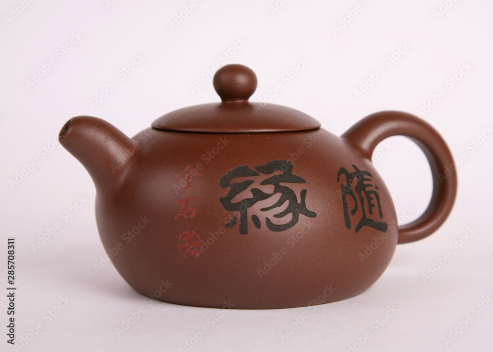 brown old isolated clay teapot on white background with hieroglyphs