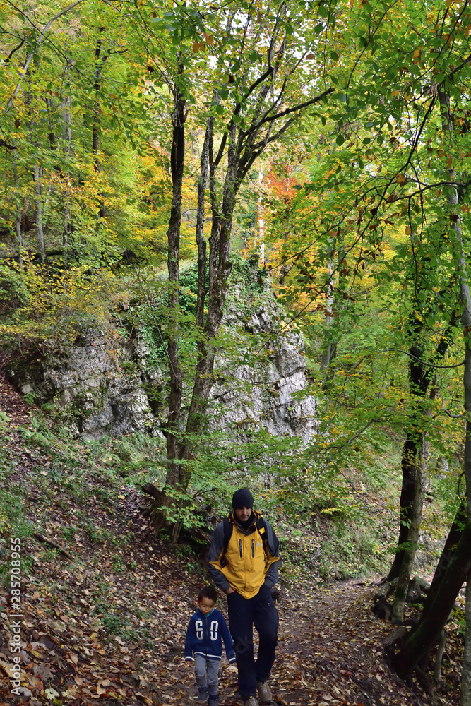 Boy and his father traveling together, hiking in Plitvice National Park, Croatia, in the fall