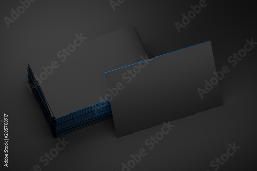 Mock up of stack of black business cards with one standing card on black background. 3d illustration. photo