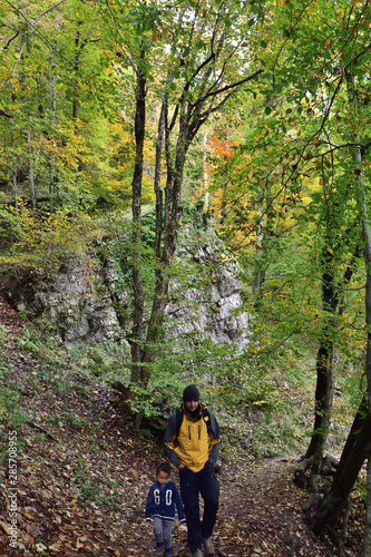 Boy and his father traveling together, hiking in Plitvice National Park, Croatia, in the fall