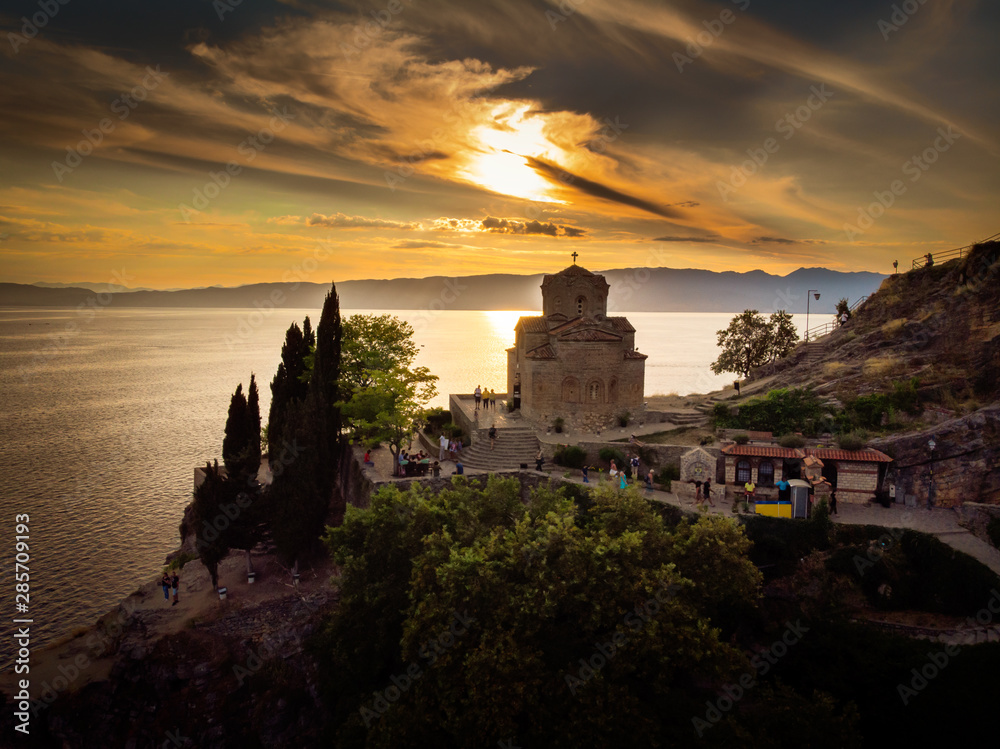 Church of St. John the Theologian  over Kaneo Beach by the Ohrid lake in North Macedonia. Aerial view in sunset.