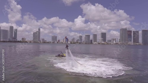 A man hovers using a water jetpack flyboard on the ocean in Miami, Florida. photo