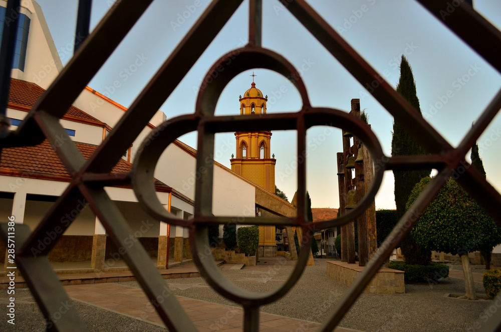 View of a church from behind a fence