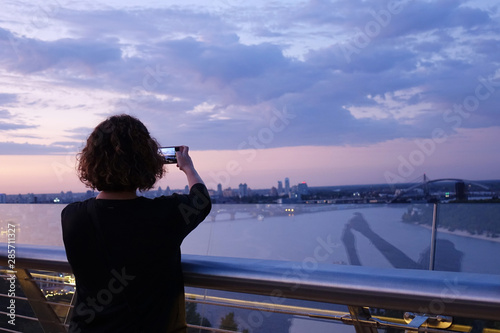 woman photographs the sunset on the Dnieper © Photobank