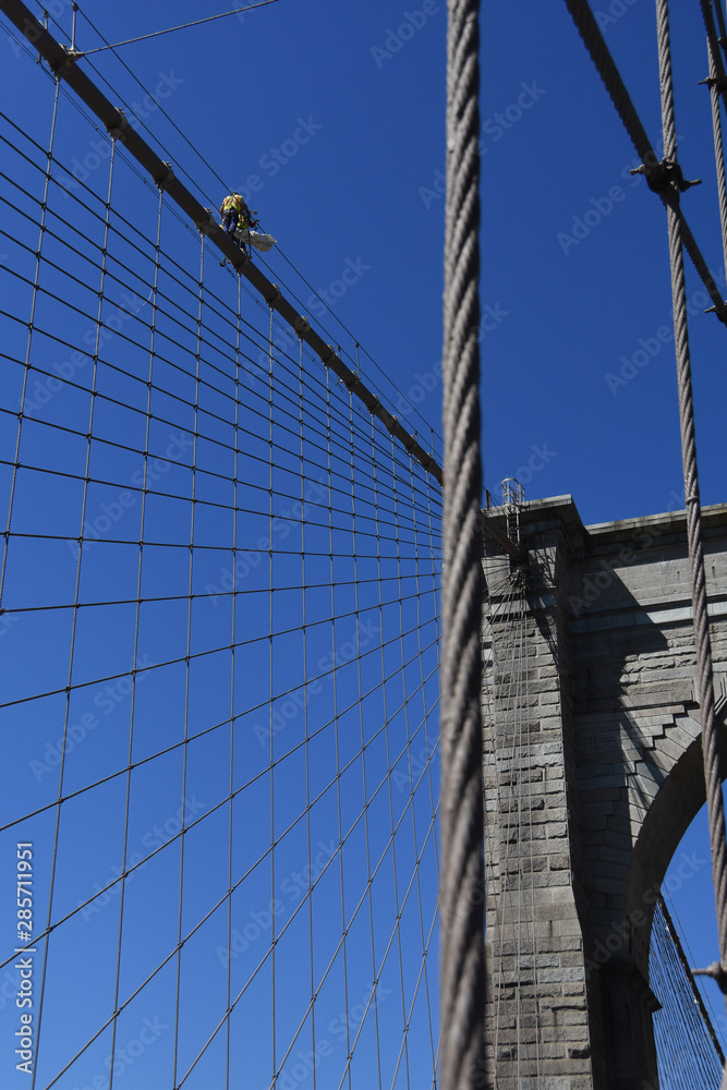 Fototapeta premium Low Angle View Of Construction Workers On Brooklyn Bridge