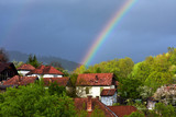 a rainbow above a village
