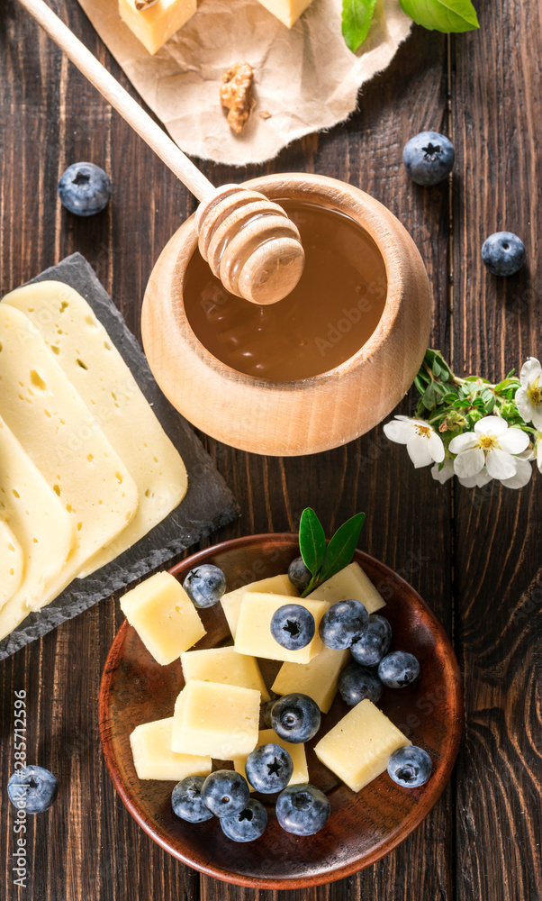 cheese with blueberries on a wooden background