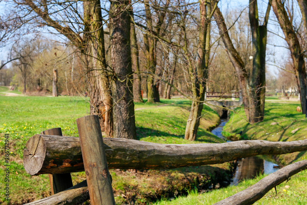 Rustic wooden fence by the stream. Rustic wooden fence by the stream.