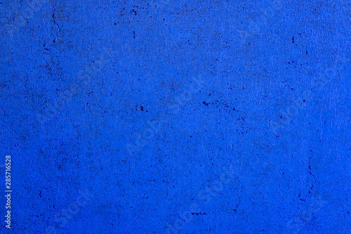 The structure of concrete is blue. Creative vintage background. Structural plaster. Modern lights in the form of a white ball on a long wire.