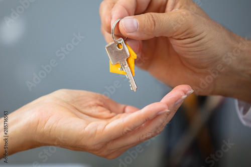 Estate Agent Giving House Key To Woman