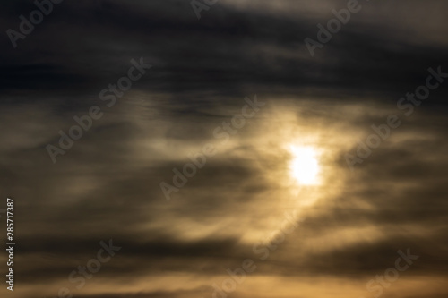 a skyscape shoot of golden sun with intense clouds