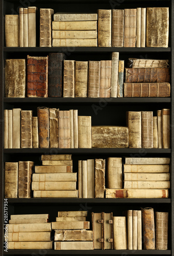antique books on old wooden shelf.