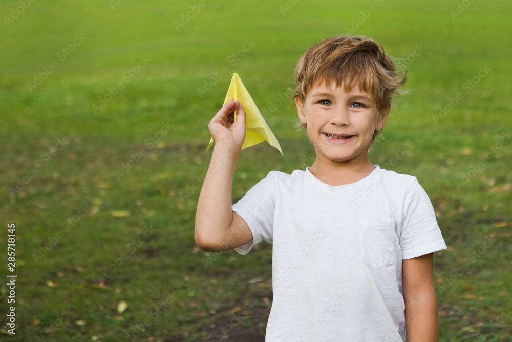 child boy playing with paper plane outdoors child boy playing with paper plane outdoors