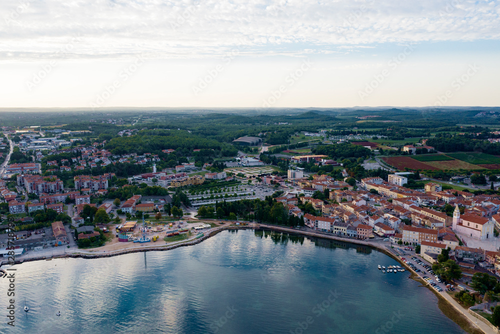 Sunrise over the sea. The coastline of the old town of Porec. Istria Peninsula, Croatia. The view from the top. Copy space.