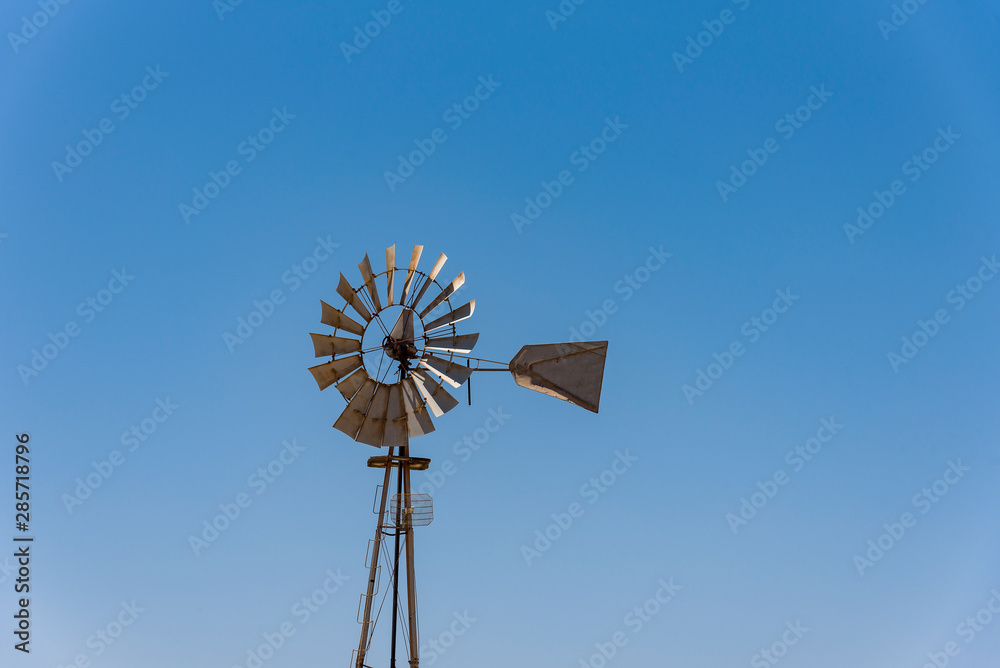 An old windmill against a blue sky in the town of Sutherland , Cyprus An old windmill against a blue sky in the town of Sutherland , Cyprus