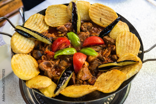 Pan-fried sac dish with meat, vegetables, mushrooms and potato, served on a hotplate in Azerbaijan.
