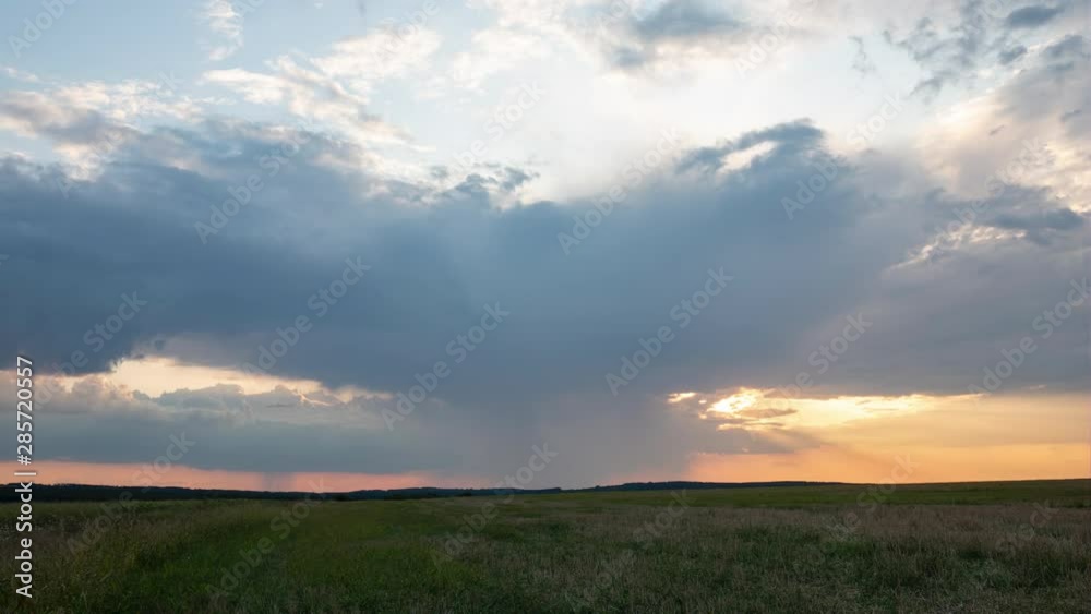 Time lapse of beautiful sunset with clouds and rain in the distance Time lapse of beautiful sunset with clouds and rain in the distance
