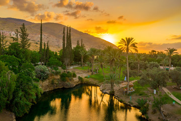 Leinwandbilder Honigfarbe Aerial view of the sunset over Sachne or Gan Hashlosha oasis, with popular waterfall in Northern Israel  © tamas