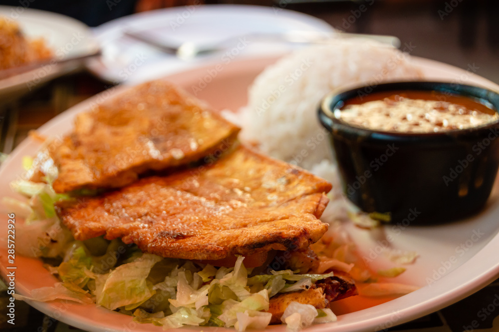 Steak Jibarito sandwich with white rice and beans on the side. Urban Puerto Rican food cuisine.