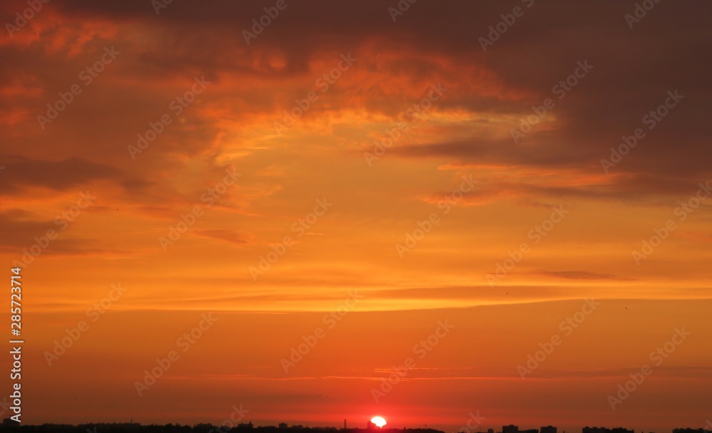 Beautiful fiery orange sunset view over the city, natural background