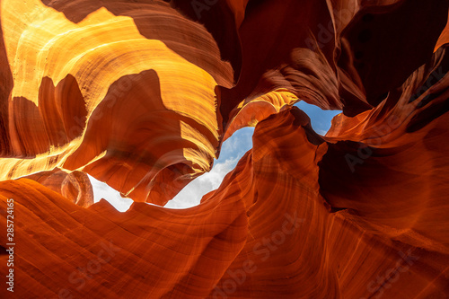 Mix of orange and red textures and curve in Lower Antelope and the blue sky above in Arizona. United States...