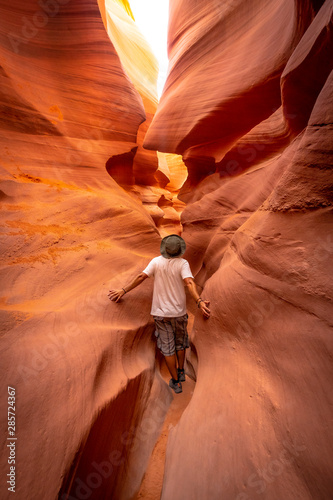 A young tourist in a crack in Lower Antelope