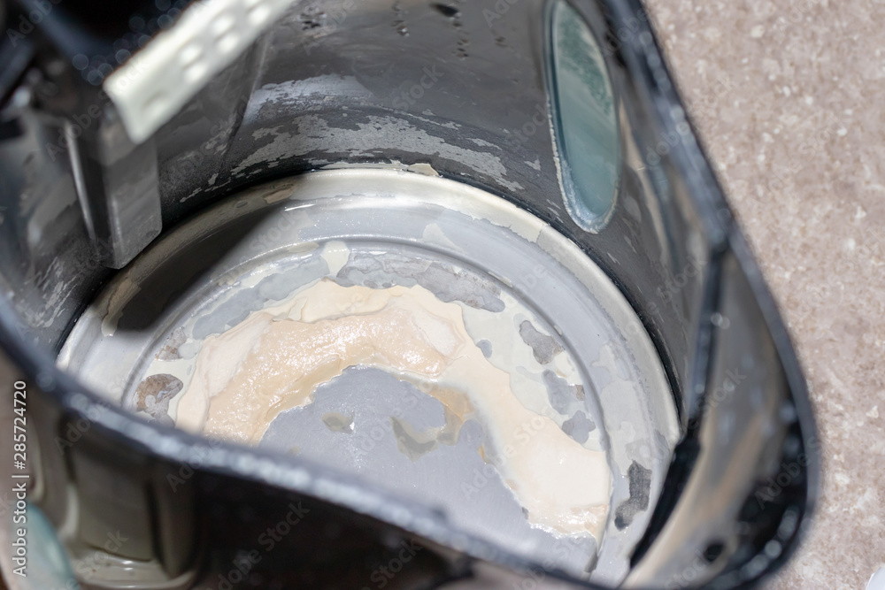 Limescale, lime scale in old kettle in kitchen. A white, chalky residue of calcium carbonate. Household appliances repair caused by hard water
