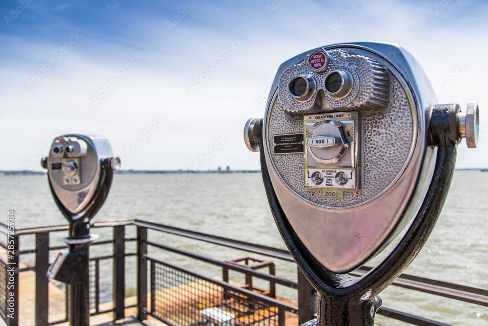 Coin operated binocular in Ellis Island with New York skyline in background Coin operated binocular in Ellis Island with New York skyline in background