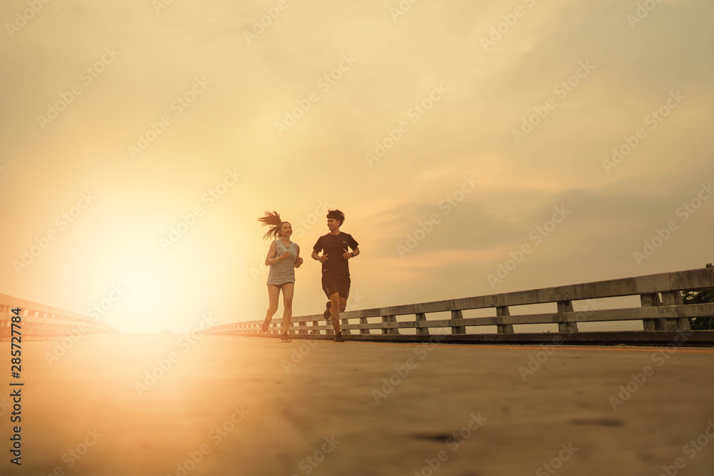 Women and men jogging in the evening for good health