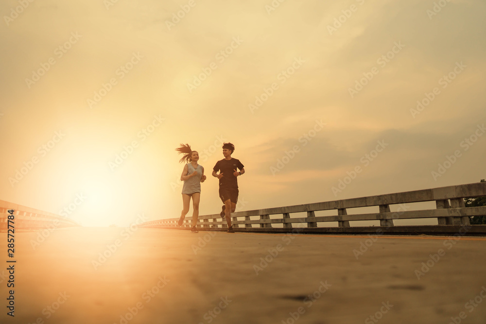 Women and men jogging in the evening for good health Women and men jogging in the evening for good health
