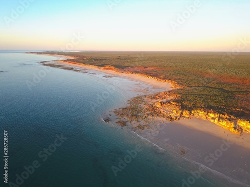 Scenic panoramic view of remote coast near Broome, Western Australia, with  ocean beach, cliffs, outback landscape, sunset sky and horizon as copy space.