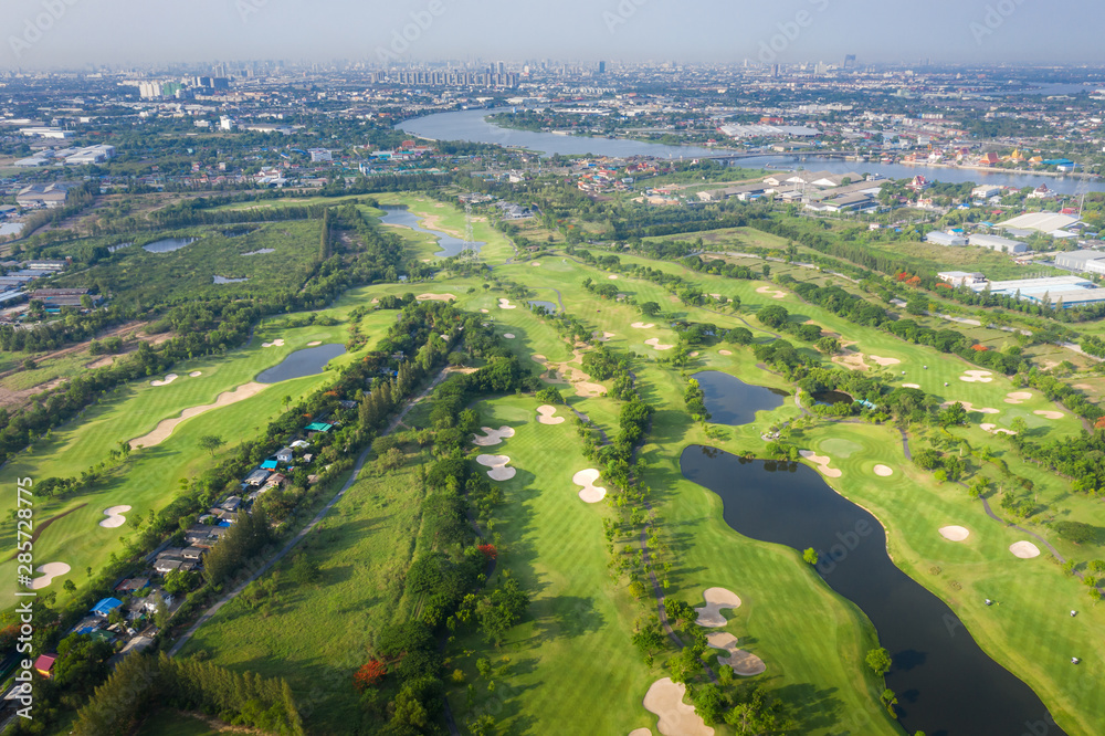 Aerial panoramic view of golf course and houses in city. Aerial panoramic view of golf course and houses in city.