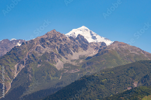 Mount Tetnuldi rises above the Great Caucasian Range in the upper Svaneti in Georgia, Mountain Landscape. photo