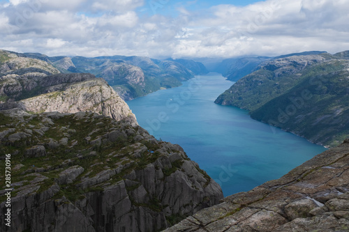 Preikestolen massive cliff (Norway, Lysefjorden summer morning view). Beautiful natural vacation hiking walking travel to nature destinations concept. July 2019