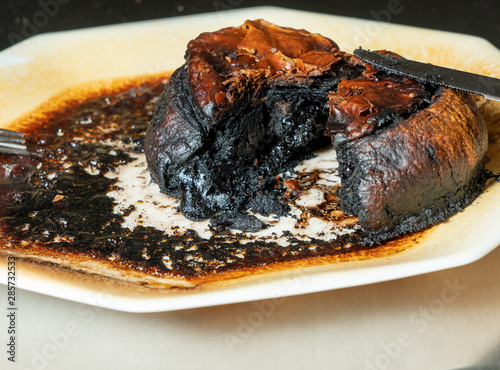 Pastry meat pie completely charred and burned after leaving in the microwave oven too long photo