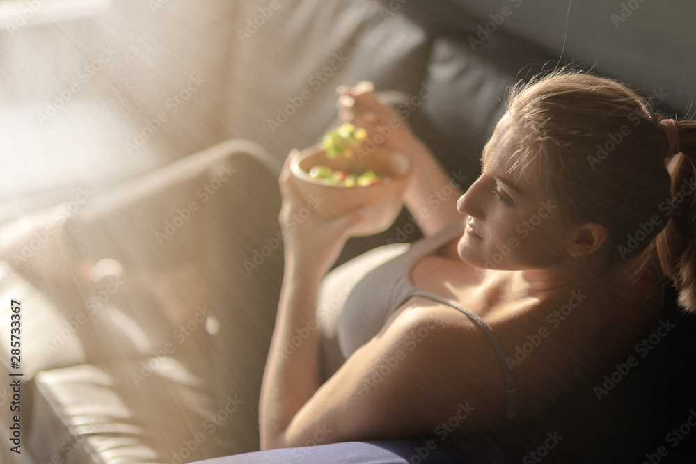 Weekend mode. Pregnant woman is going to eat a salad. Copy space on the left side Weekend mode. Pregnant woman is going to eat a salad. Copy space on the left side