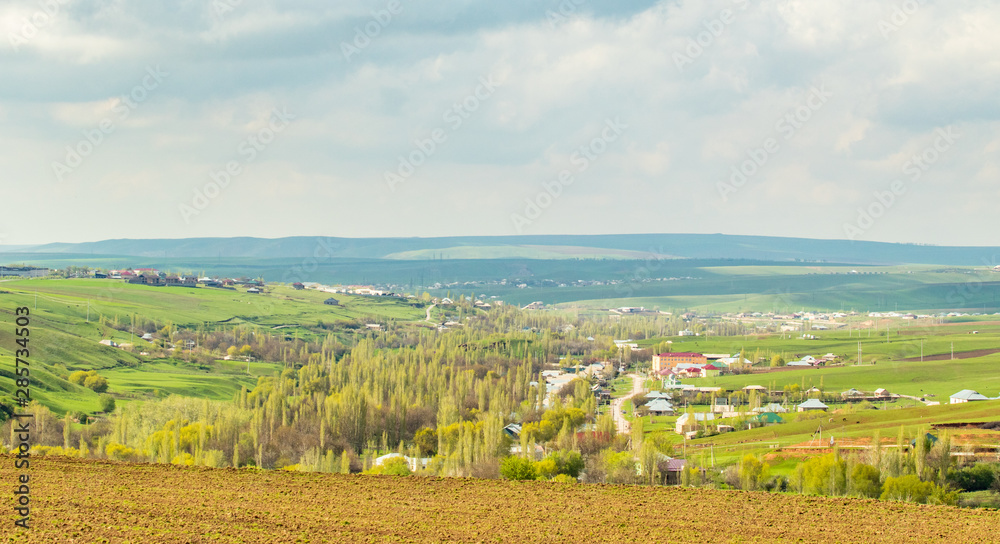 Landscape green field hills sky with clouds