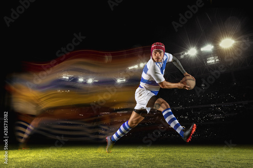 New star of the competitive. One caucasian man playing rugby on the stadium in mixed light. Fit young male player in motion or action during sport game. Concept of movement, sport, healthy lifestyle. © master1305