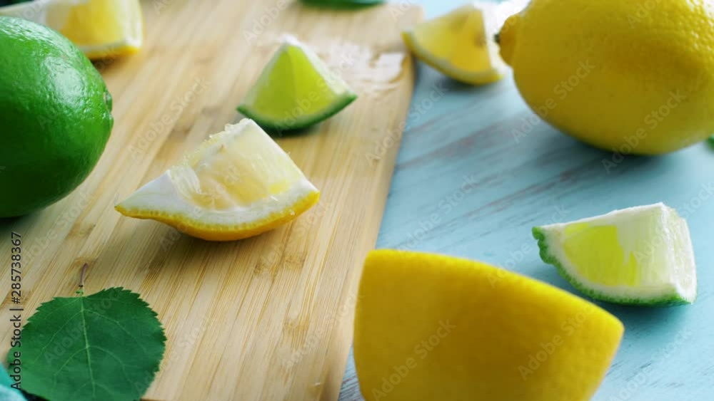 Sliced lemon and lime on wood kitchen surface. Citrus fresh fruits. Close up 4k footage. Sliced lemon and lime on wood kitchen surface. Citrus fresh fruits. Close up 4k footage.