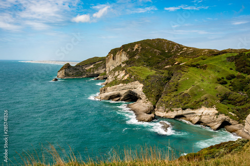 Dramatic coastal cliff and cave scenery at Cape Farewell in Nelson New Zealand