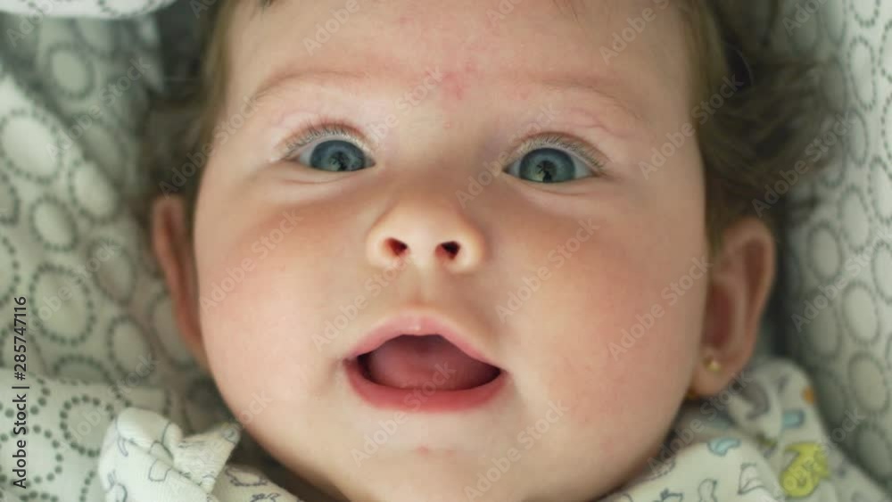 Close-up in slow motion of beautiful baby looking at camera Close-up in slow motion of beautiful baby looking at camera