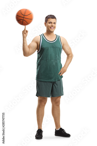 Basketball player standing and spinning a ball on a finger