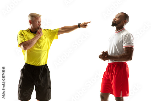 Referee gives directions with gestures to football or soccer players while gaming isolated on white studio background. Concept of sport, rules violation, controversial issues, obstacles overcoming.
