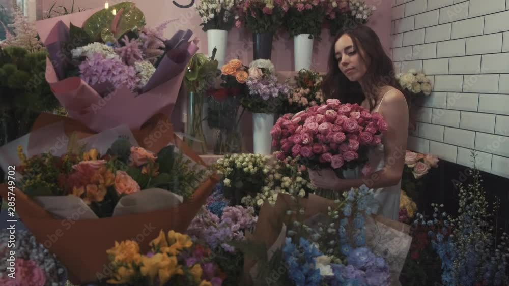 elegant woman picking out a flower bouquet at the florist shop elegant woman picking out a flower bouquet at the florist shop