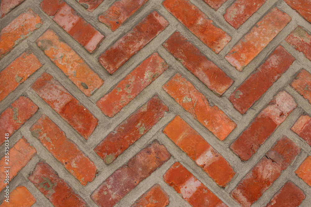 Background, orange brick wall with a herringbone pattern image taken horizontally Background, orange brick wall with a herringbone pattern image taken horizontally