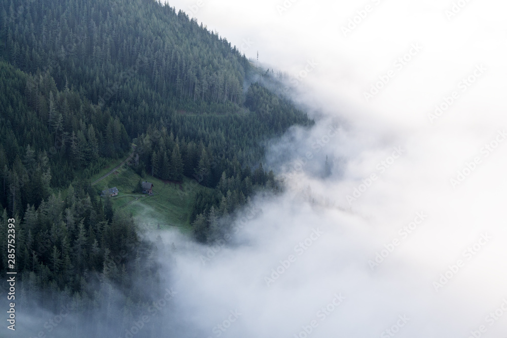 view of flying clouds over valley in mountains view of flying clouds over valley in mountains