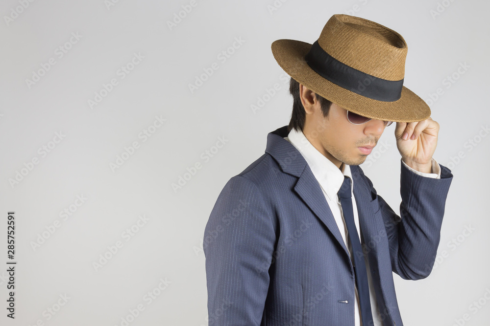 Young Asian Portrait Businessman in Navy Blue Suit Wear Sunglasses and Hat at Right Frame Young Asian Portrait Businessman in Navy Blue Suit Wear Sunglasses and Hat at Right Frame