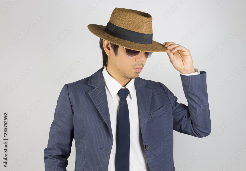 Young Asian Portrait Businessman in Navy Blue Suit Wear Sunglasses and Hat at Front View Young Asian Portrait Businessman in Navy Blue Suit Wear Sunglasses and Hat at Front View